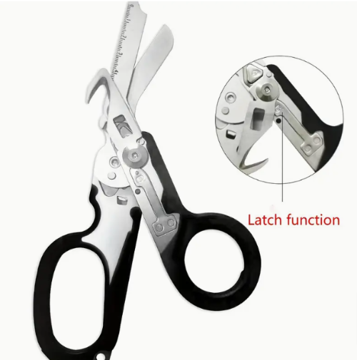 A pair of stainless steel trauma shears with a black handle, displayed alongside its opened case which reveals multiple tools such as a folding knife, ruler, and glass breaker.