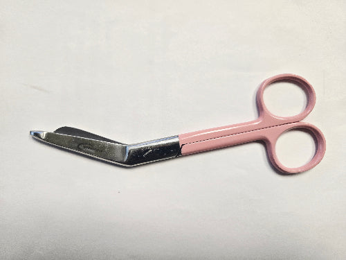 Pink-handled scissors on a light gray background