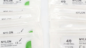 Two packages of nylon sutures with visible branding and product details.