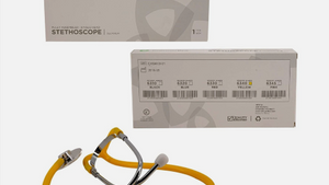 Yellow stethoscope with its packaging on a white background