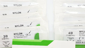 A box of Nylon absorbable sutures, with individual packaging for each suture. The box is labeled 'STERILER Surgical Sutures' and has a 'Store in cool dry place' instruction.