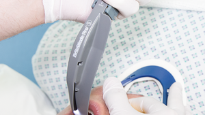 A person is being intubated with a Mac 4 laryngoscope blade which is attached to a fiber-optic handle, held by a healthcare professional.