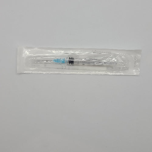 Medical syringe in a clear plastic package on a gray background