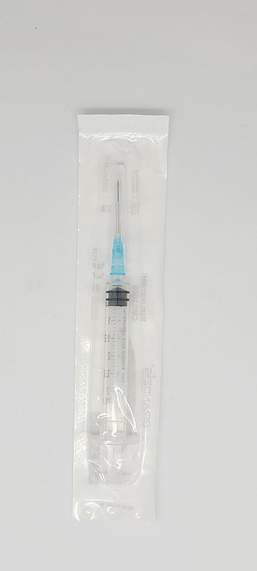 Medical syringe with needle in a clear plastic package on a gray background