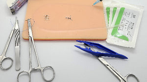 A venipuncture kit including a syringe, needles, scissors, a surgical skin stapler, staple remover, suture tools, a suture removal kit, a carry case, and a stylus pen.